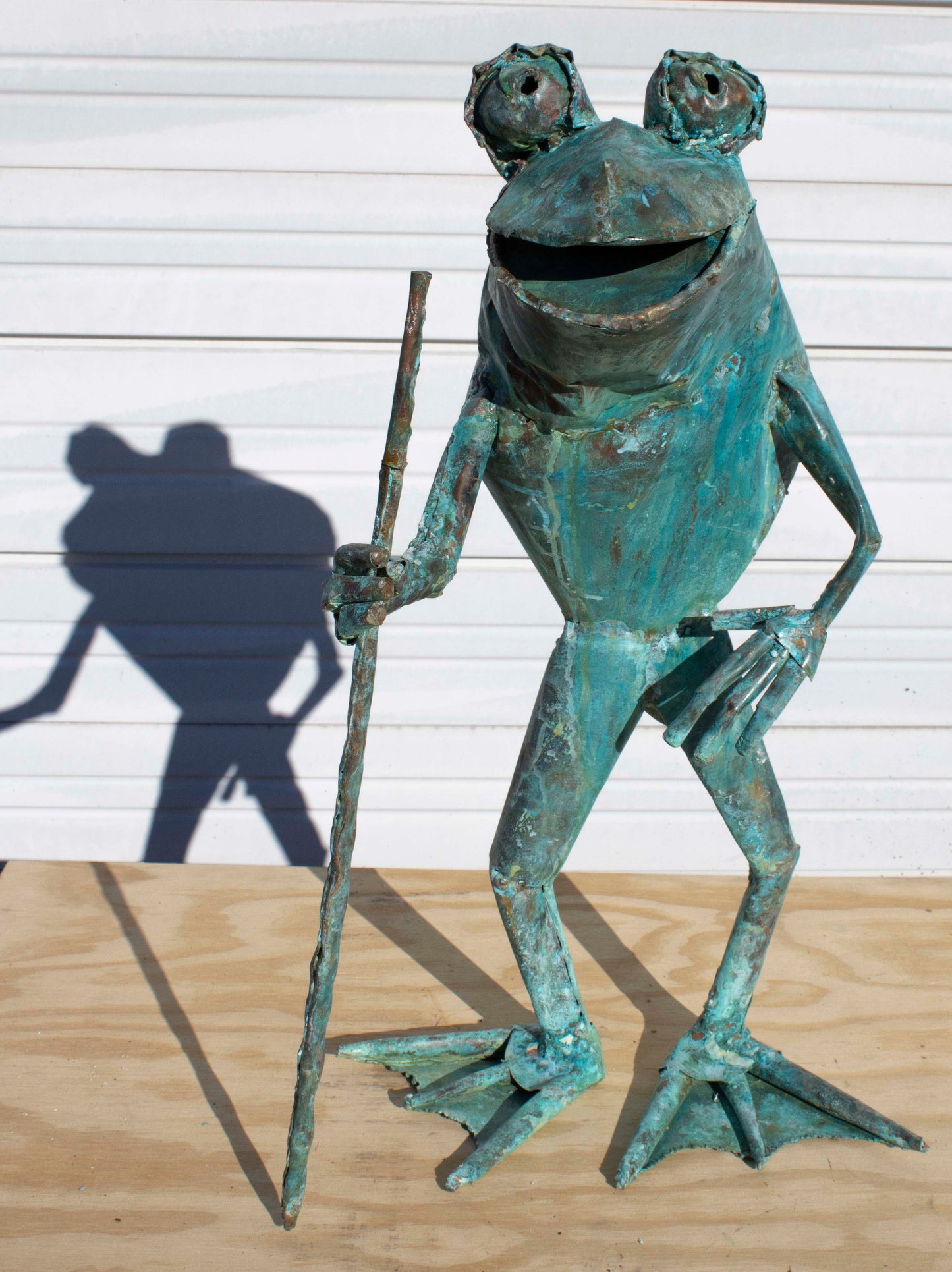 standing copper Frog sculpture with cane by Beau Smith