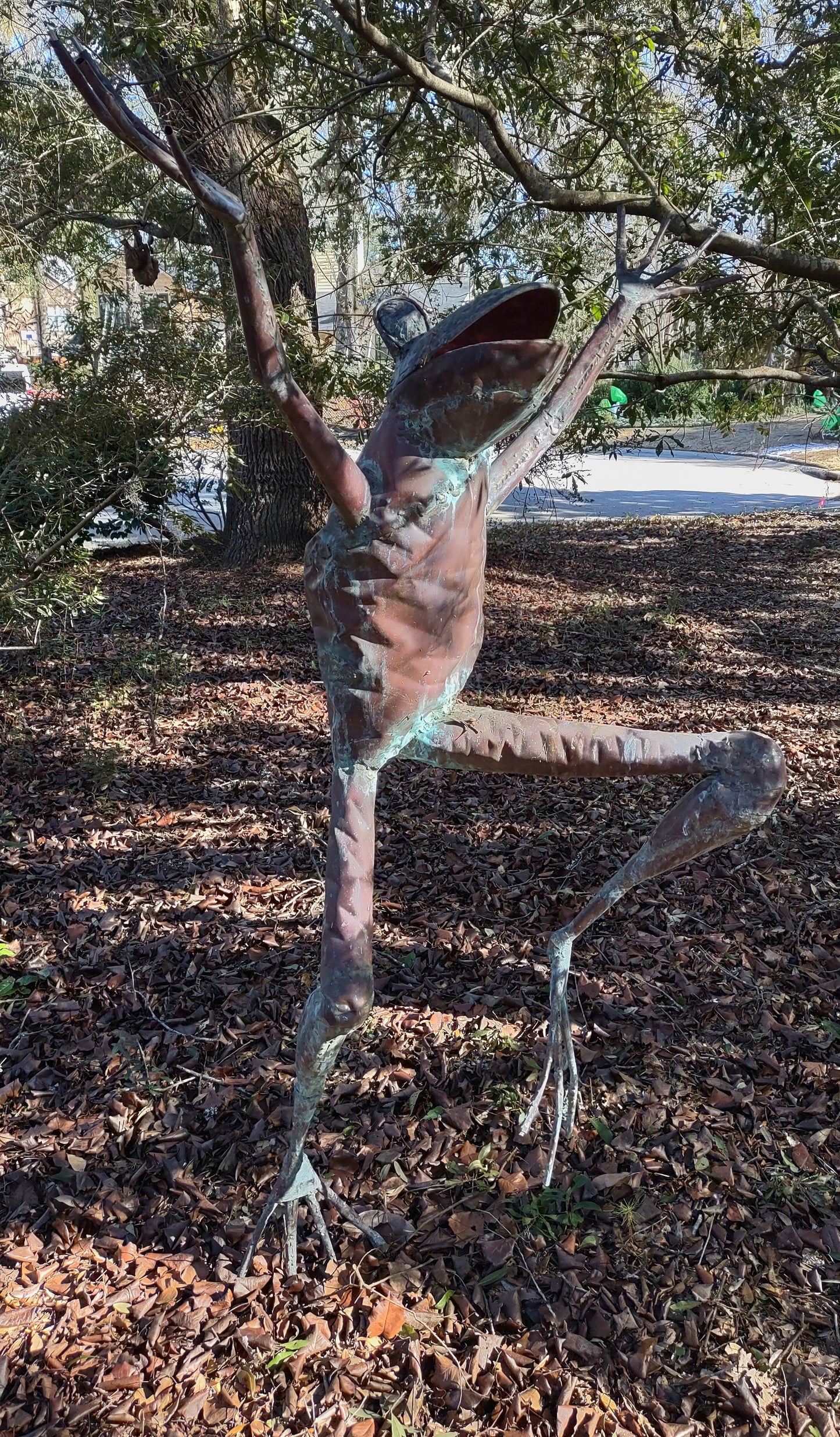Leaping adult human-sized copper frog sculpture