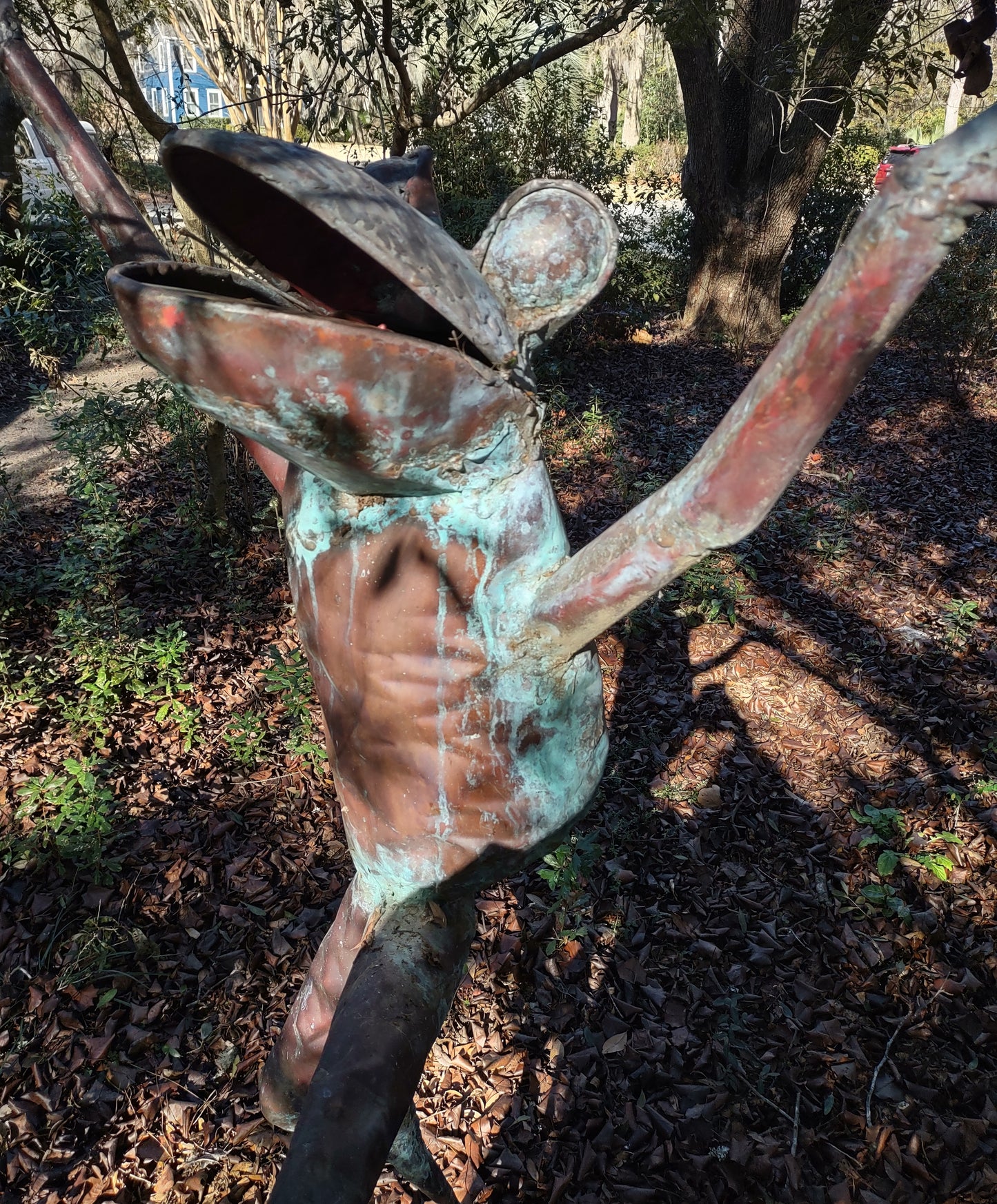 Leaping adult human-sized copper frog sculpture
