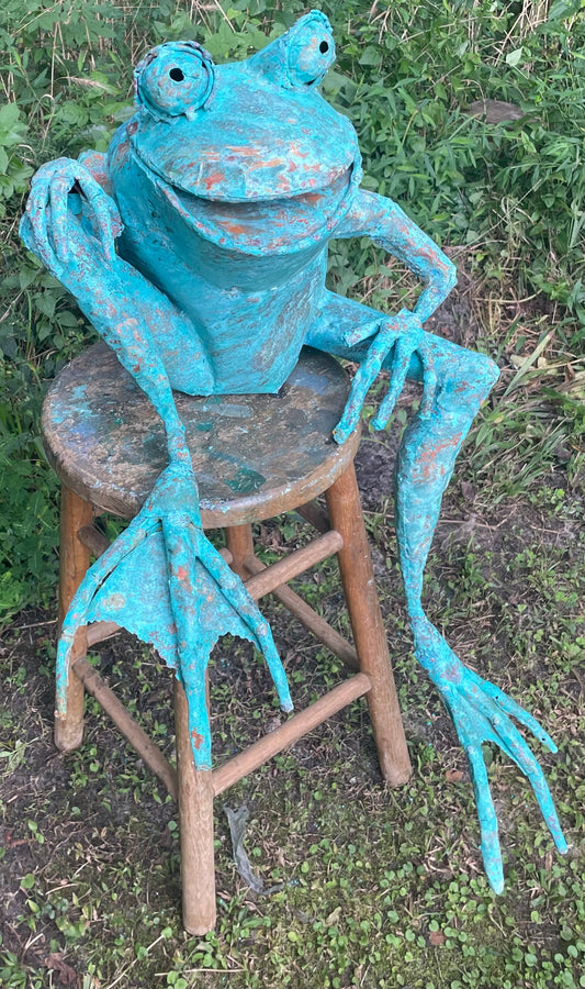 Sitting happy frog, leg dangling