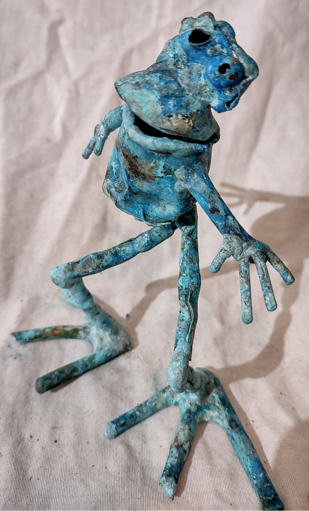 whimsical copper frog sculpture, looking to one side froglette