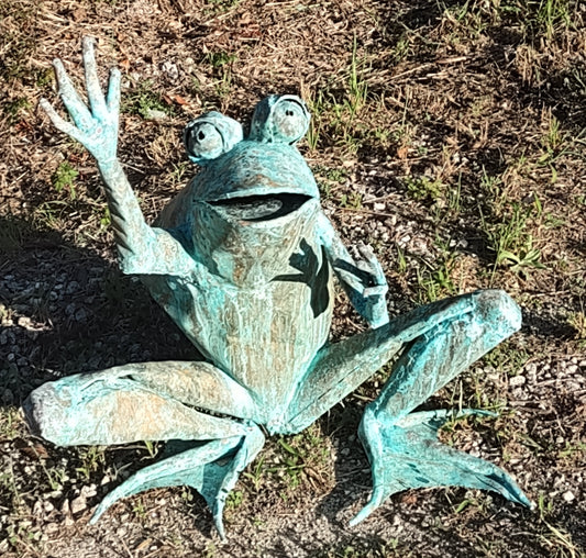 Child size squat frog with legs, arms up, preparing to jump or catch something