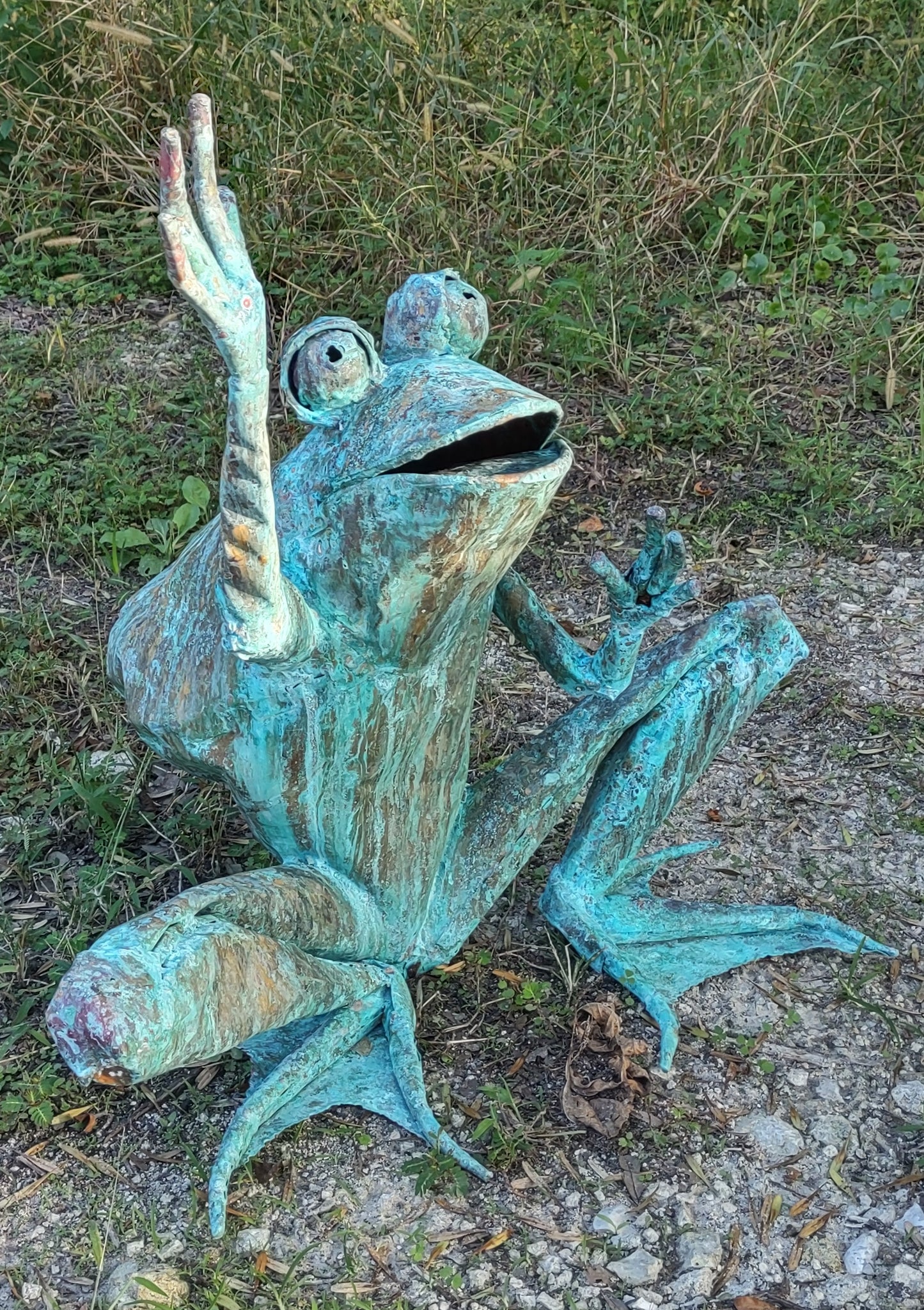 Child size squat frog with legs, arms up, preparing to jump or catch something