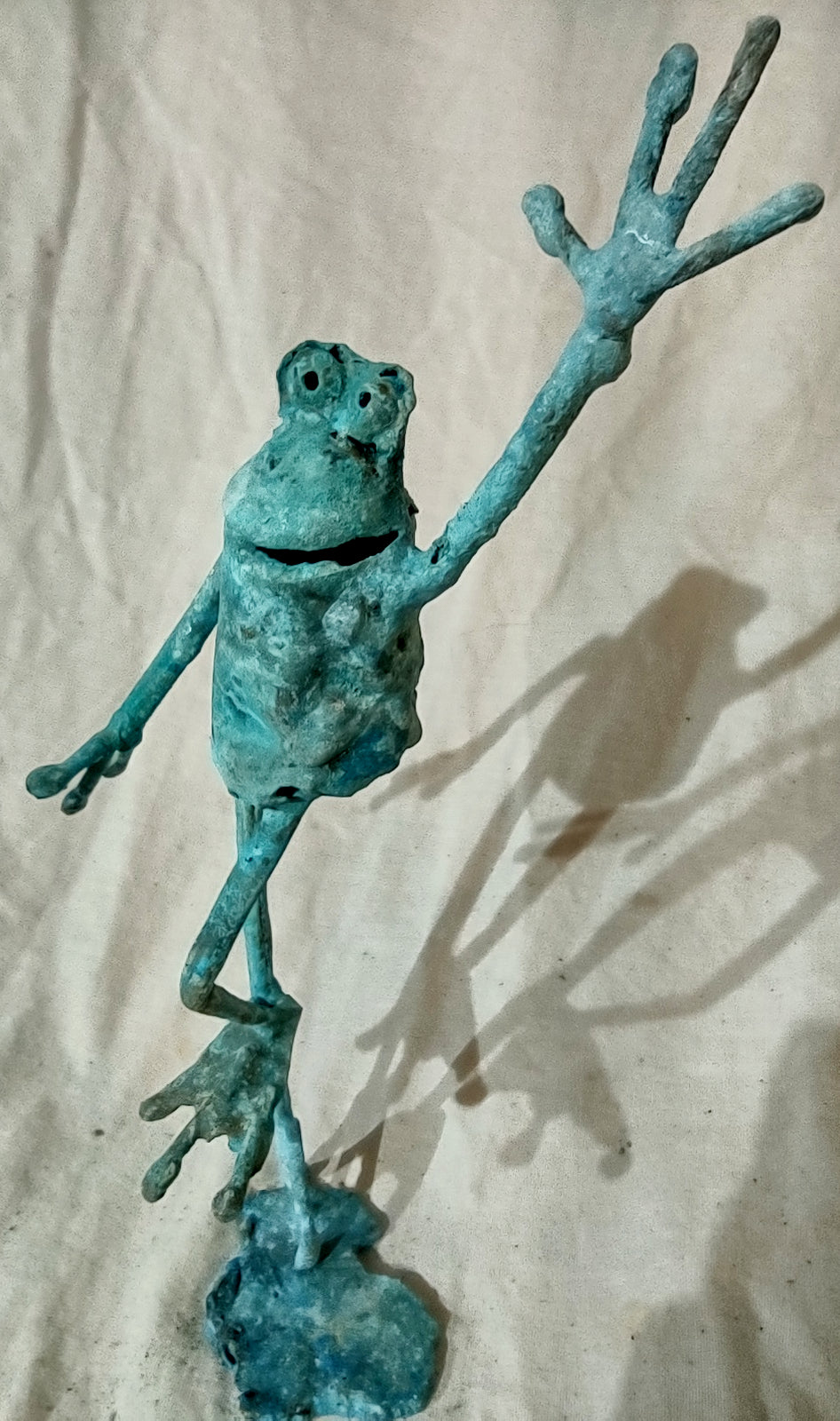 standing on one foot copper froglette arm raised