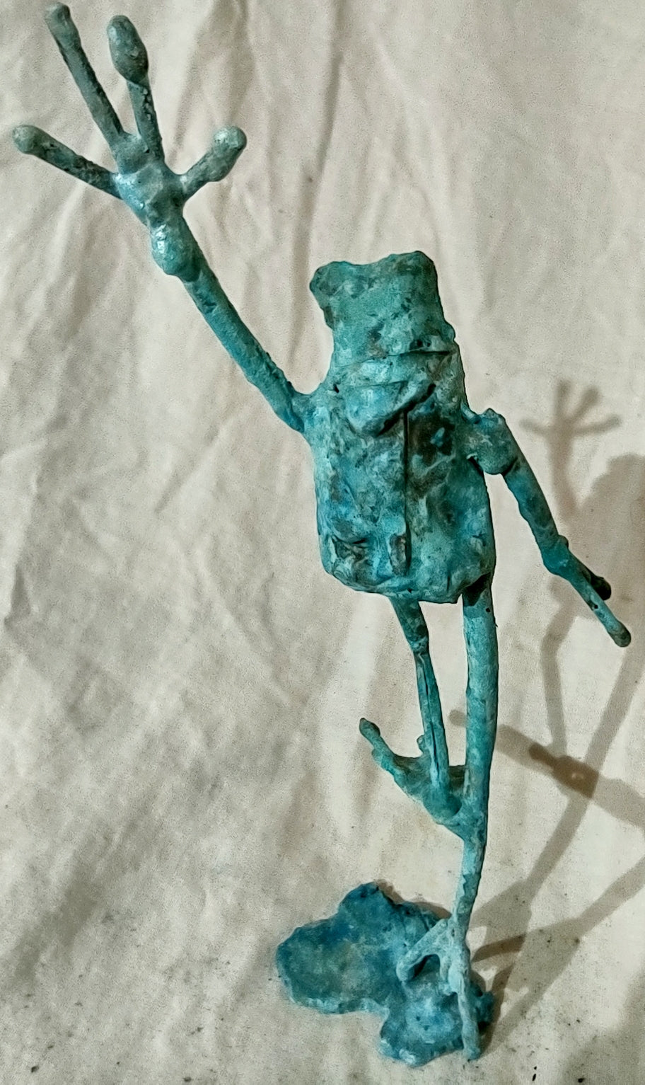 standing on one foot copper froglette arm raised