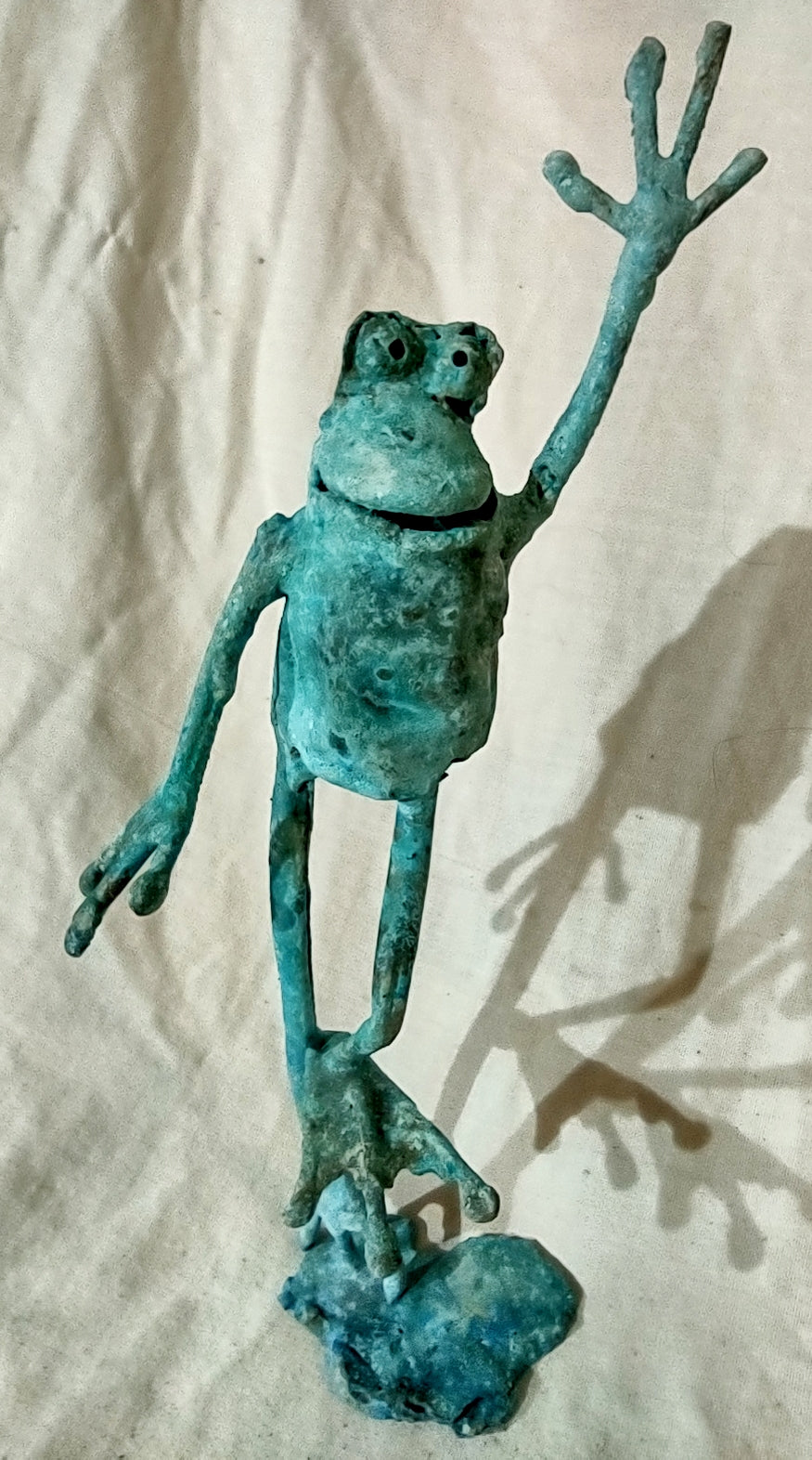 standing on one foot copper froglette arm raised