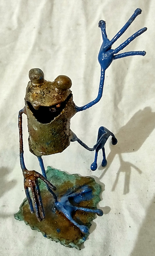 Tiny frog sculpture waving.