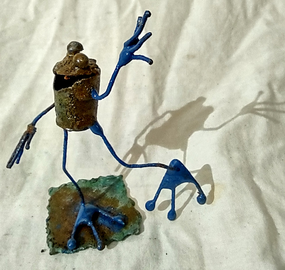 Tiny frog sculpture waving.