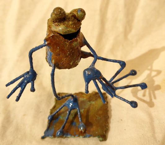 Tiny frog sculpture, taking a step